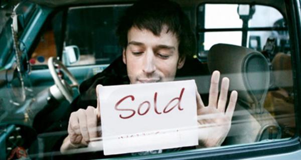 sold sign in car