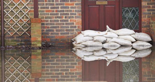 sand bags against a door preventing flood water entering