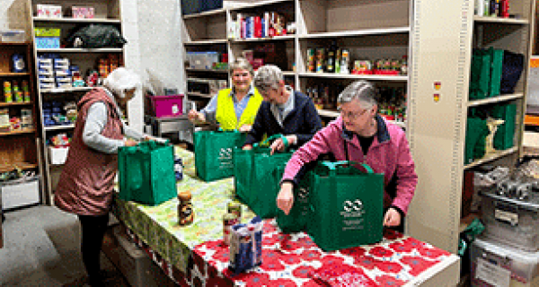 Women packing groceries into bags