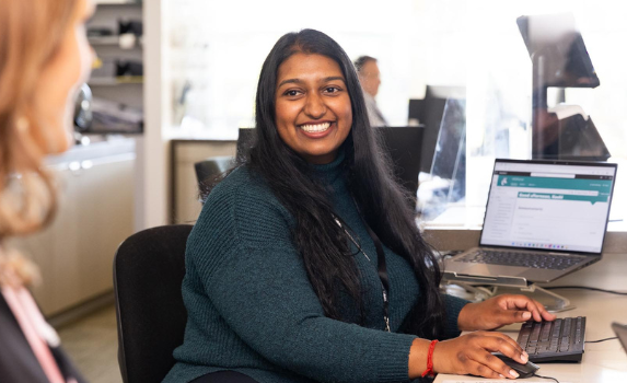 A customer service officer smiling