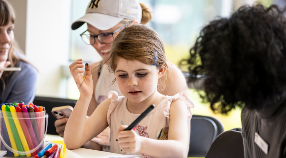 young child colouring in at festival 