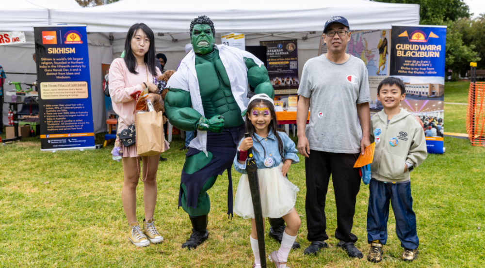 family posed with super hero (Hulk) at Festival