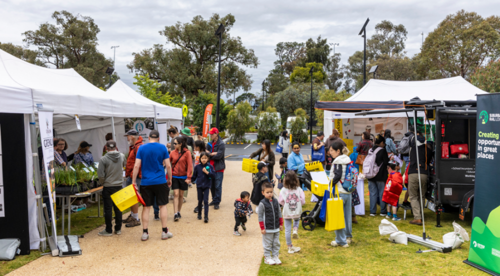 group of people standing at marquees at a festival