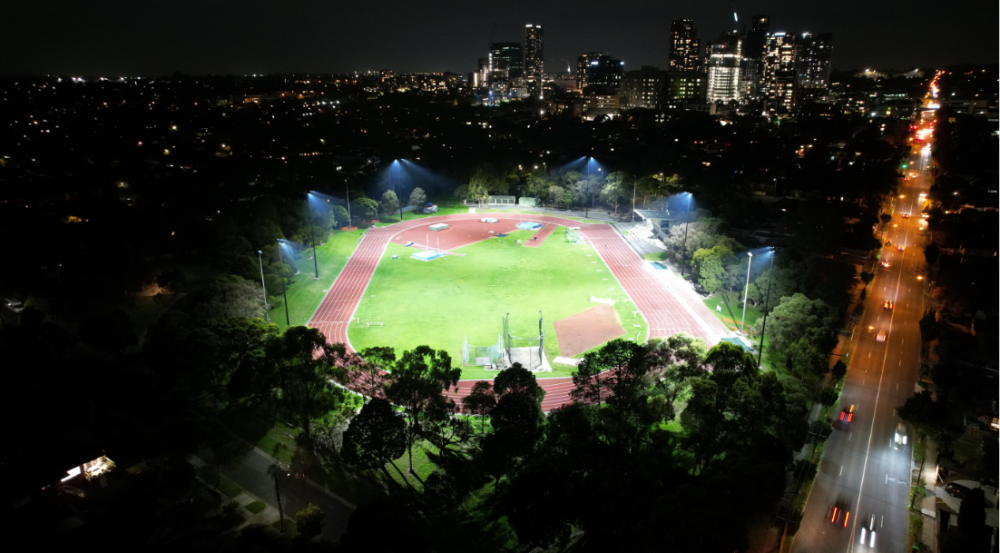 athletics running track lit up at night