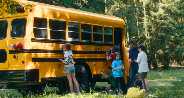 Scene of Future Council with yellow bus and kids
