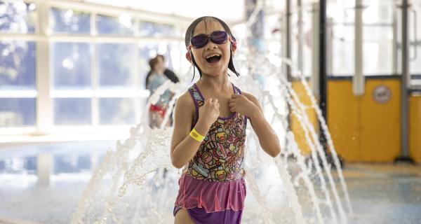 Young child playing at the pool