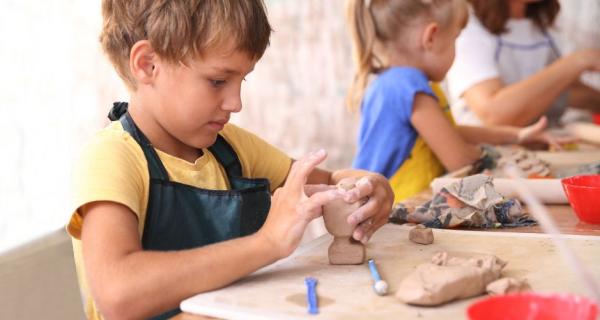 boy making clay snowman