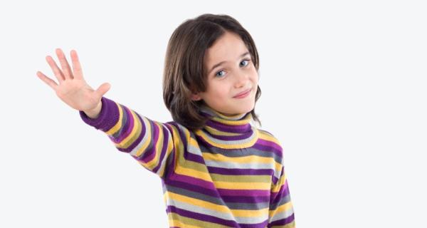 Young child with striped top with a hand out indicating to stop