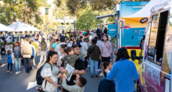 crowd of people lining up for a food truck