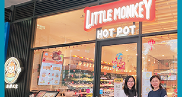 Little Monkey Hot Pot shop front with the owners standing out the front