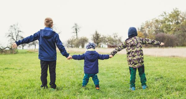 Three children holding hands