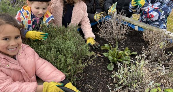 kids gardening in raised garden bed