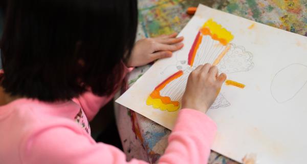 girl creating butterfly art 