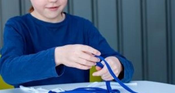 Girl making a tee using fabric and yarn 