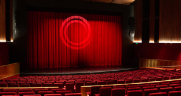 The Round theatre with a closed red curtain