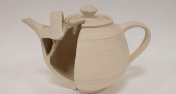 clay teapot carved in half so you can see inside the teapot