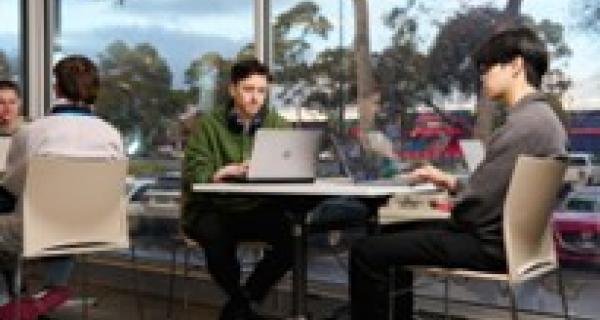 Young People working in an open plan office by the window