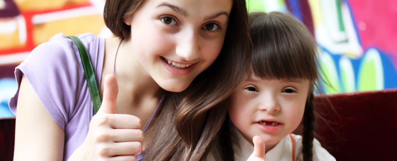 Mother and daughter signing thumbs up