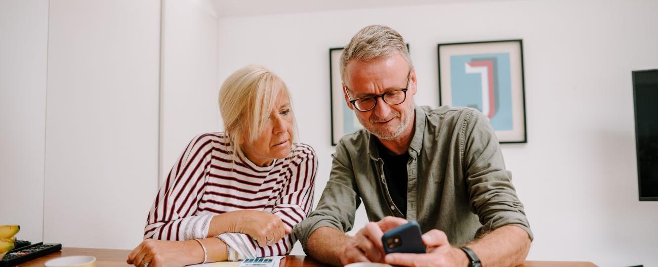 Women and Man looking at mobile phone 